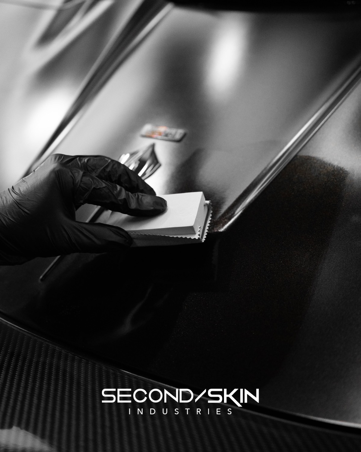 Ceramic coating applied to a glossy black panel with an applicator