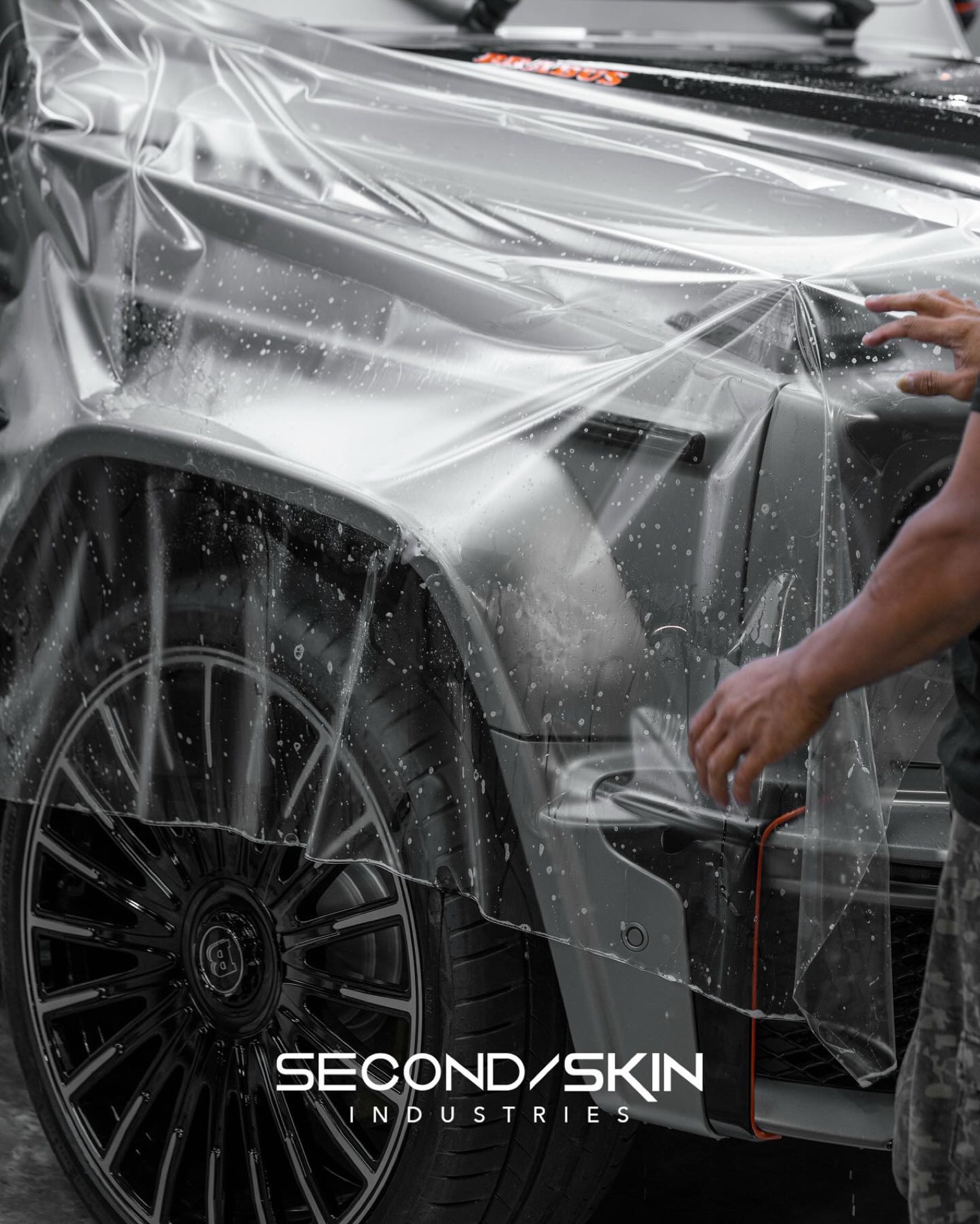 Paint protection film being installed on a luxury SUV