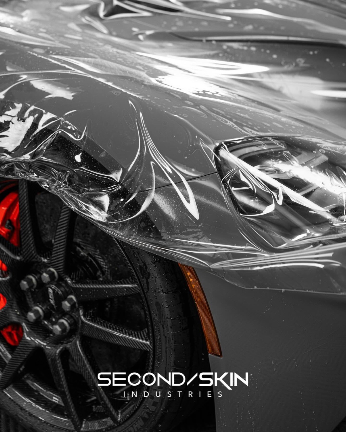 Clear self-healing paint protection film laid over a sports car fender